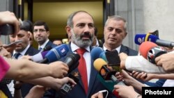 Armenia's new Prime Minister Nikol Pashinian speaks to reporters shortly after taking office in May 2018.