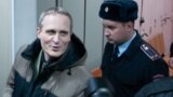 RUSSIA -- Dennis Christensen is escorted inside a courthouse following the verdict announcement in the town of Oryol, February 6, 2019