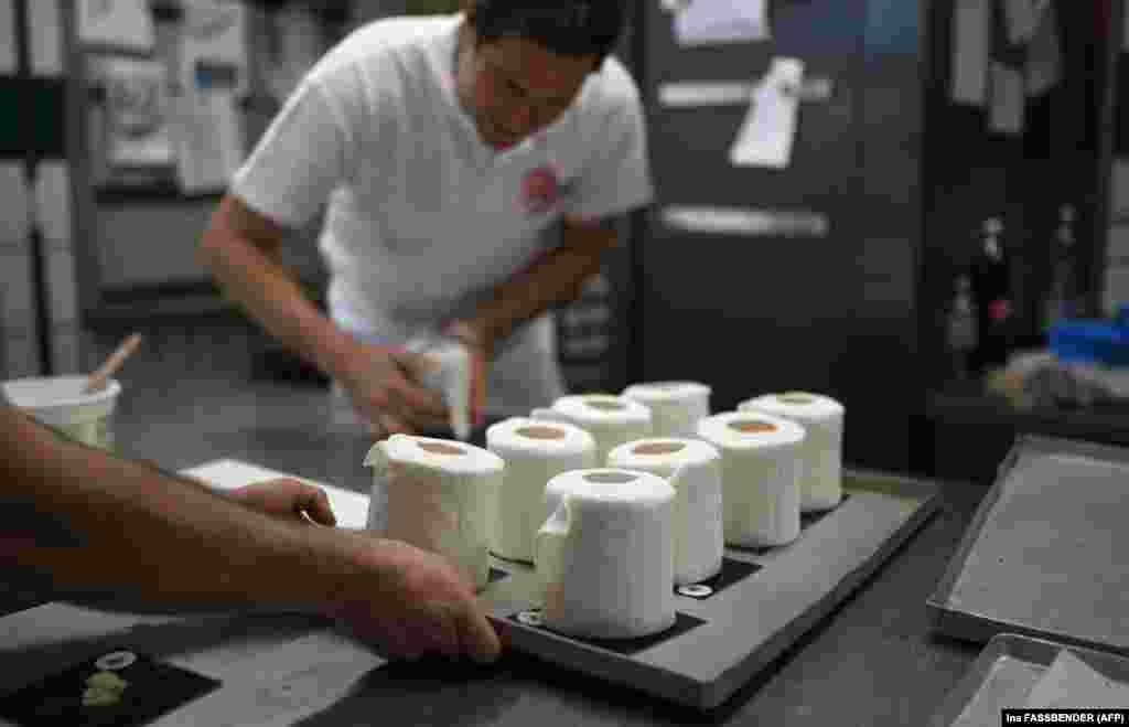 Тим Кортуем подготвува торти во форма на тоалетна хартија во неговата пекарница во Дортмунд, Германија.