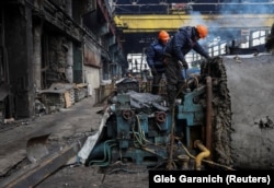 Workers at a Ukrainian thermal power plant hit by a Russian strike in Novermber 2024