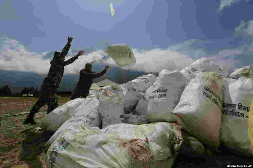 Nepalese soldiers pile up the garbage collected from Mount Everest in Namche Bajar on May 27.&nbsp;(AP/Niranjan Shrestha)&nbsp;