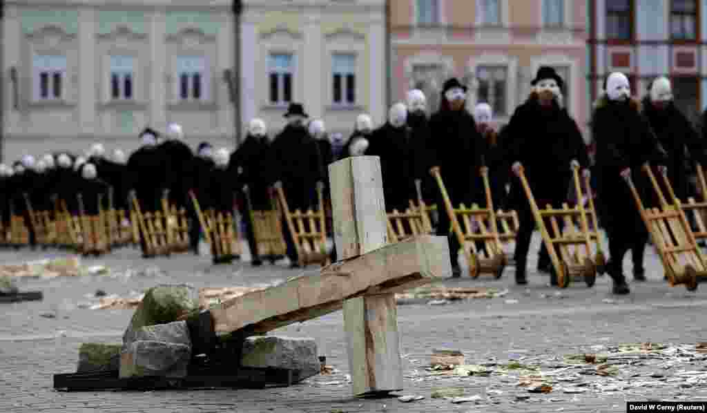 People wearing masks march through the streets during Easter celebrations in the Czech city of Ceske Budejovice on March 30. (Reuters/David Cerny)