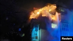 Firefighters work at the site of an apartment building hit by a Russian drone strike in Chernihiv, Ukraine, on March 15. 