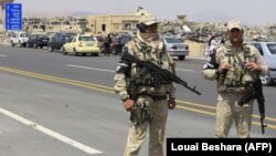 Russian military police stand on a highway outside Damascus last month.