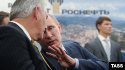 Russian President Vladimir Putin and Rex Tillerson (left) when he was chief executive of Exxon Mobil at the signing of an agreement to drill in the Black Sea with Rosneft in 2012