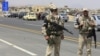 Russian military police stand on a highway outside Damascus last month.