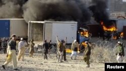 Smoke rose from burning supply trucks for NATO forces during a protest in Khost Province on February 24. Protests were continuing the following day.