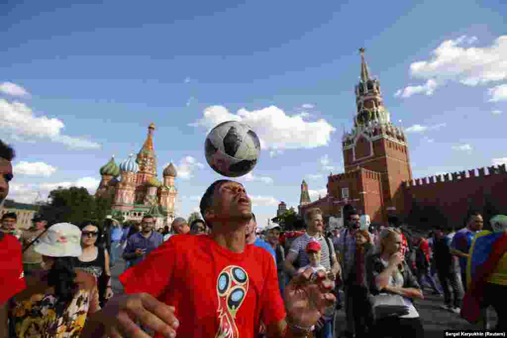 A Moroccan soccer fan plays with a football on Moscow's Red Square after his country's World Cup match with Portugal on June 20. (Reuters/Sergei Karpukhin)