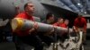 Aviation Ordnancemen transport a missile aboard the Nimitz-class aircraft carrier USS Abraham Lincoln in the Persian Gulf, May 10, 2019