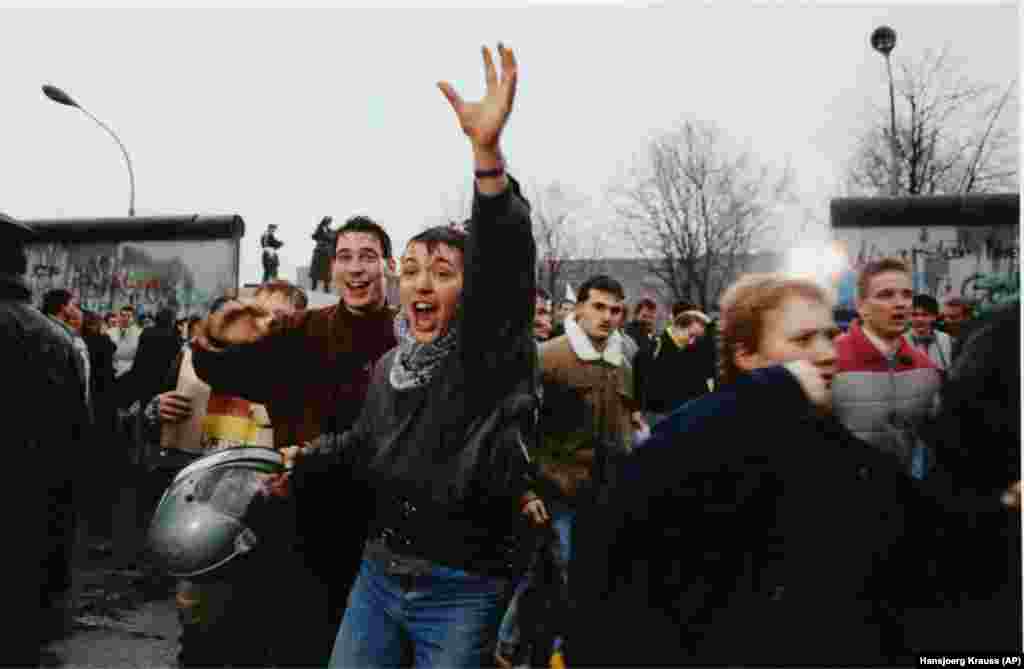 Young East Berliners celebrate as they enter the West through an opening in the Berlin Wall in December 1989.After the Berlin Wall fell and one after another of Europe’s communist regimes collapsed, RFE/RL had its budget slashed by nearly two thirds amid debate over the radio's future.