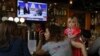 Christine Fox and her daughter Emmylou Fox from Washington State wait for the results of the United States midterm elections during a gathering organized by Democrats Abroad in Beijing, China, Wednesday, Nov. 7, 2018. Democrats were poised to seize the Ho