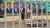 A car drives past a campaign banner in the village of Arashan, some 20 kilometers from Bishkek, on September 30.