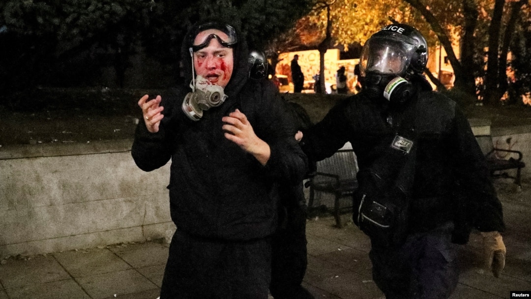 A Georgian police officers detains a demonstrator during an opposition rally in Tbilisi on November 30. 