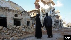 Жители Алеппо возле разрушенного дома в северо-восточном районе Хайдарии, декабрь 2016 года