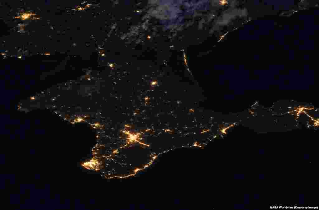 South of the Donbas, on the Russian-held Crimean Peninsula, darkness recently prevailed in many areas due to an ongoing Ukrainian drone campaign targeting Crimea's electricity network. These images were taken on July 8, 2021 and July 3, 2026.