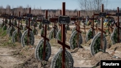 Graves of unidentified people killed by Russian soldiers during the occupation of the Bucha, outside Kyiv, are seen at the town's cemetery on March 30 ahead of the one-year anniversary of when Russian forces withdrew. 