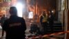 Police officers and investigators work at the scene where two men were killed in a suspected grenade explosion on Pushkin Street in downtown Kyiv on October 23.