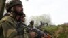 FILE: Indian soldiers look on during clashes between suspected rebels and Indian forces in Badgam district south of the regional capital Srinagar.