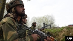 Indian Army soldiers look on during clashes between suspected rebels and Indian forces in Chadoora, in Badgam district south of Srinagar, in March.