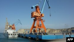 FILE: Pakistan Naval soldiers stand guard at the port of Gwadar in April. 