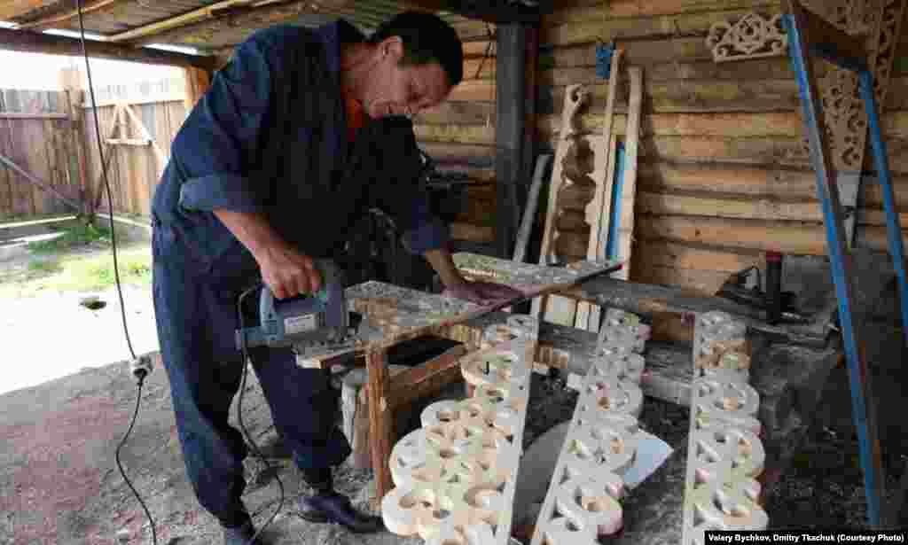 A local carpenter produces traditionally ornate wooden window frames.