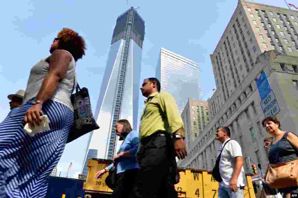 With the redevelopment well under way, lower Manhattan is bustling once again. Here, people walk past the One World Trade Center tower on August 8, 2012.