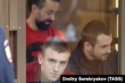 Ukrainian sailors Serhiy Tsybizov (left), Andriy Opyshko (center), and Roman Mokryak attend a court hearing in Moscow on February 12.