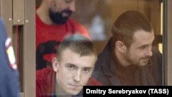 Ukrainian sailors Serhiy Tsybizov (left), Andriy Opyshko (center), and Roman Mokryak attend a court hearing in Moscow on February 12.