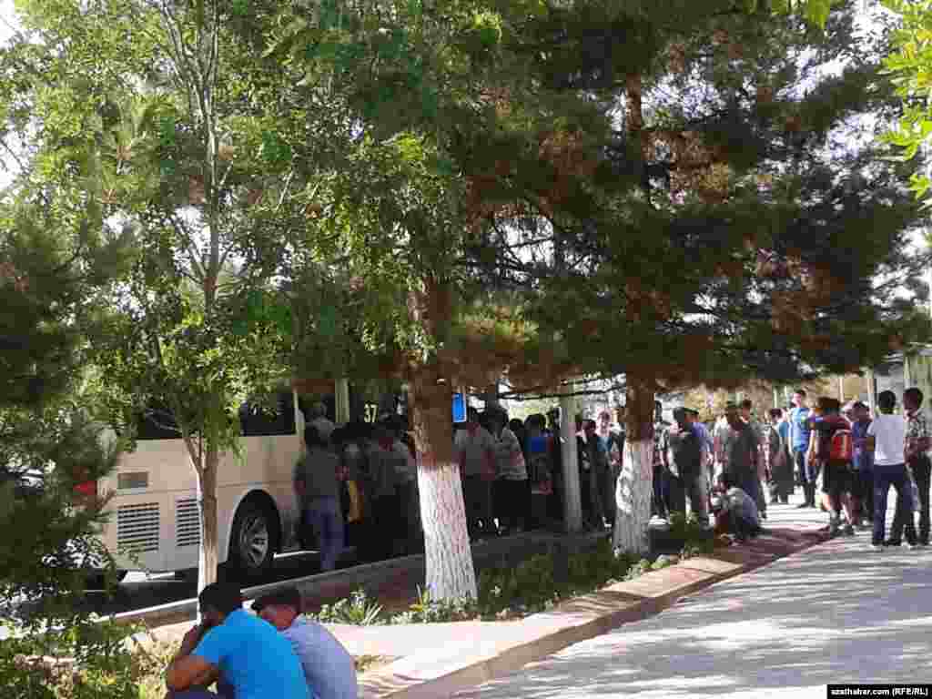 Awtobus üçin nobata duran ýolagçylar