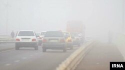 Pedestrians and cars cross a bridge during heavy fog in Ahvaz, Iran.