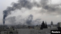 Black smoke rises near Homs after oil pipeline hit on February 15.