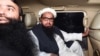 FILE: Hafiz Saeed, leader of the Jamaat-ud-Dawa (JuD) organisation Hafiz Saeed (R) leaves in a car after being detained by the police in the eastern city of Lahore in January.