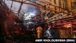 First responders search for survivors at the scene of an explosion at the Sina At'har health centre in the north of Iran's capital Tehran northern Tehran on June 30, 2020. - 