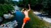 A boy jumps into the River Treska during a hot day, near Skopje in North Macedonia.