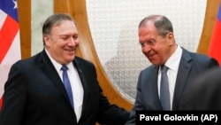 Russian Foreign Minister Sergei Lavrov (right) welcomes U.S. Secretary of State Mike Pompeo for talks in the Black Sea city of Sochi on May 14. 