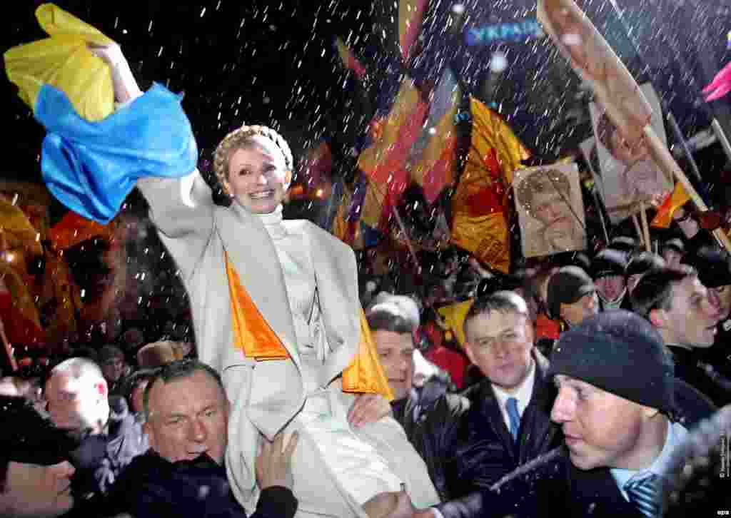 Yulia Tymoshenko's supporters carry her during a massive rally in Kyiv in November 2005 to mark the first anniversary of the Orange Revolution.