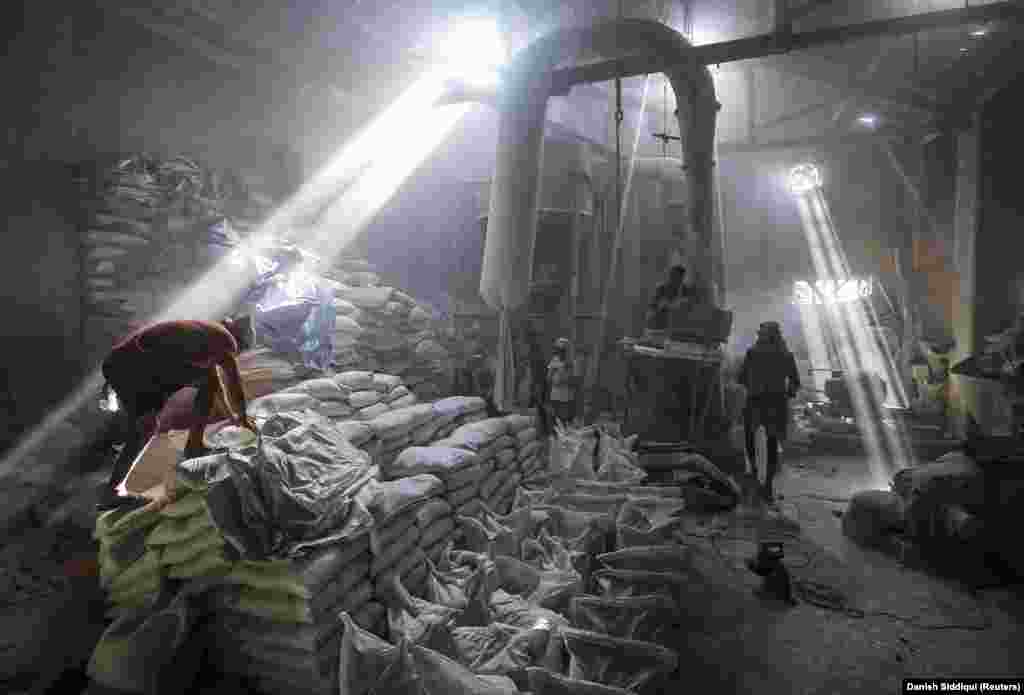 Employees work inside a limestone-powder factory in an industrial area of Mumbai on March 11, 2014.&nbsp;