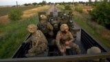 UKRAINE – Ukrainian servicemen ride in a truck with cannon, as Russia's attack on Ukraine continues, in Mykolaiv Region, June 15, 2022