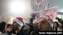 Dvojica studenata tokom protestne šetnje centrom Beograda izražavaju svoj revolt duvanje u pištaljke, dok se iza njih, između ostalih, vidi i transparent sa porukom "Dečija revolucija". 31. decembar 2024.