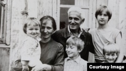 Mikhail Loshchinin (center, front) as a child in Ufa, in then-Soviet Russia. His grandmother holds a toddler.
