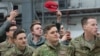 (FILES) A member of the US military holds up a "Make America Great Again" hat as US President Donald Trump and First Lady Melania Trump greet members of the US military during a stop at Ramstein Air Base in Germany, on December 27, 2018.