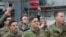 (FILES) A member of the US military holds up a "Make America Great Again" hat as US President Donald Trump and First Lady Melania Trump greet members of the US military during a stop at Ramstein Air Base in Germany, on December 27, 2018.