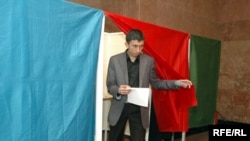 A man leaves a polling booth at a polling station in Baku.