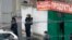Police officers stand guard outside the candy factory after the shooting in Moscow on December 27.