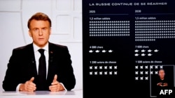 President Emmanuel Macron (L) addresses the nation on live TV, with a graphic outlining a projection of Russia's military strength shown on screen on March 5.