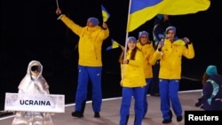 Анастасія Кучерова (ліворуч у сріблястому одязі) під час церемонії відкриття Олімпіади, 6 лютого 2026 року