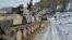 Azerbaijani soldiers sit atop their military vehicle on a road in Kalbacar, a district ringing Nagorno-Karabakh, on November 25, 2020.