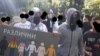Част от участниците в хомофобската акция са носели ЛГБТ лозунг "Различни, но равни", надраскан със свастика