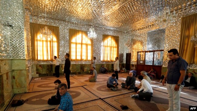 Iranian men pray during the holy fasting month of Ramadan in Emamzadeh Saleh mosque on Tajrish square in northern Tehran, June 7, 2016,