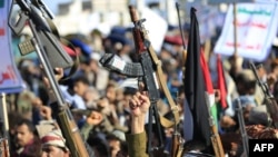 Houthis hold their weapons as they rally in solidarity with Iran and Lebanon, amid the US-Israeli war with Iran, in the Yemeni capital Sanaa on March 27.